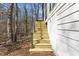 Exterior view of the home highlighting the newly built wooden staircase to the deck at 5709 Russell Rd, Durham, NC 27712