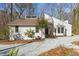 Charming exterior view of a modern home with unique architectural details and fresh, white siding with well-maintained landscaping at 5709 Russell Rd, Durham, NC 27712