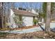 Exterior angle view of a modern home with unique architectural details and fresh, white siding with well-maintained landscaping at 5709 Russell Rd, Durham, NC 27712
