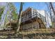 Home exterior showing the deck and screened-in porch with stairs to the yard at 5709 Russell Rd, Durham, NC 27712