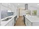 Beautiful kitchen with white counters and cabinets and stainless appliances at 5709 Russell Rd, Durham, NC 27712