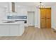 Modern kitchen boasts white cabinets, stainless steel appliances, and a stylish barn door at 5709 Russell Rd, Durham, NC 27712