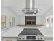 Open floor plan from modern kitchen with island cooktop overlooking living room fireplace at 5709 Russell Rd, Durham, NC 27712