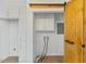 Laundry room featuring wood sliding door and white cabinets at 5709 Russell Rd, Durham, NC 27712