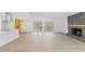 Spacious living room with modern floors, stone fireplace, and sliding glass doors to the outdoor deck at 5709 Russell Rd, Durham, NC 27712