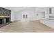 Spacious living room with modern floors, stone fireplace, and open concept kitchen at 5709 Russell Rd, Durham, NC 27712