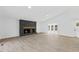 Spacious living room featuring stone fireplace and ample natural light at 5709 Russell Rd, Durham, NC 27712