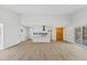 Spacious living room with modern floors, open concept kitchen and an outdoor deck at 5709 Russell Rd, Durham, NC 27712