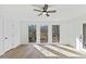 Sunroom featuring many windows, a door to the outdoors, and a ceiling fan at 5709 Russell Rd, Durham, NC 27712