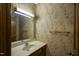 Small half bathroom with updated vanity and floral wallpaper at 610 Denim Dr, Erwin, NC 28339