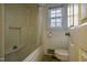 Bathroom with tub shower, toilet and window at 610 Denim Dr, Erwin, NC 28339