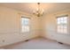Bright dining room with two windows, chandelier, and neutral decor at 610 Denim Dr, Erwin, NC 28339