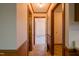 Hallway with wood-paneled walls and neutral flooring at 610 Denim Dr, Erwin, NC 28339