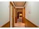 Long hallway with wood paneling and carpet at 610 Denim Dr, Erwin, NC 28339