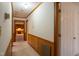 A long hallway with wood paneling and carpeted floors at 610 Denim Dr, Erwin, NC 28339