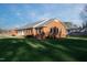 Ranch style brick home with mature lawn and landscaping at 610 Denim Dr, Erwin, NC 28339