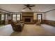 Living room with brick fireplace, rocking chair and large windows at 610 Denim Dr, Erwin, NC 28339