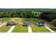 Aerial view of craftsman homes with large driveways and surrounded by lush trees at 6294 River Rd, Fuquay Varina, NC 27526
