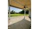 Spacious covered patio featuring a wood ceiling, fan and views of the green backyard at 6294 River Rd, Fuquay Varina, NC 27526