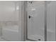 Modern bathroom featuring a sleek, glass-enclosed shower and separate soaking tub at 6294 River Rd, Fuquay Varina, NC 27526
