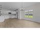 Dining room boasts stylish chandelier and an expansive view of the landscaped yard at 6294 River Rd, Fuquay Varina, NC 27526