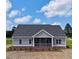 Charming one-story home featuring gray siding, brick foundation and a cozy screened-in front porch at 6294 River Rd, Fuquay Varina, NC 27526