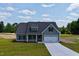 Beautiful one-story home with an attached two car garage and manicured lawn and landscape at 6294 River Rd, Fuquay Varina, NC 27526