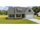 Charming exterior view of house features manicured lawn and attached two-car garage at 6294 River Rd, Fuquay Varina, NC 27526