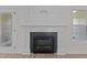 Close-up of a modern fireplace featuring a stylish tile surround and classic white mantel at 6294 River Rd, Fuquay Varina, NC 27526