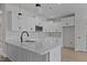 Kitchen with white cabinets, stainless steel appliances, and island with seating at 6294 River Rd, Fuquay Varina, NC 27526