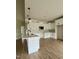 Bright, modern kitchen featuring white cabinets, granite countertops, and stylish pendant lighting at 6294 River Rd, Fuquay Varina, NC 27526