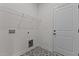 Functional laundry room with geometric tile flooring, white shelving, and ample outlets at 6294 River Rd, Fuquay Varina, NC 27526