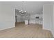 Open-concept view features modern lighting and flows into a connected kitchen space at 6294 River Rd, Fuquay Varina, NC 27526