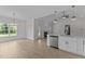 Open-concept living space with fireplace, stainless steel appliances, and modern fixtures at 6294 River Rd, Fuquay Varina, NC 27526