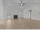 Spacious living room featuring a fireplace, vaulted ceiling, and access to the outdoors at 6294 River Rd, Fuquay Varina, NC 27526