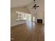 Bright and airy living room featuring a fireplace, ceiling fan, and open access to the kitchen at 6294 River Rd, Fuquay Varina, NC 27526