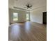 Spacious main bedroom with tray ceiling, fan, and large windows offering natural light and a view at 6294 River Rd, Fuquay Varina, NC 27526