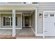 Inviting covered front porch of a new home with classic details and ample natural light at 6294 River Rd, Fuquay Varina, NC 27526