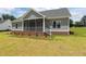 Charming home featuring brick accents and a screened porch at 6294 River Rd, Fuquay Varina, NC 27526