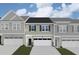 Two-story townhome with neutral siding, two-car garage, and well-manicured lawn at 7127 Hubner Pl # 25, Cary, NC 27519