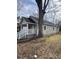 Side view of tan house with white porch and railing, large tree nearby at 715 Star St, Rocky Mount, NC 27804