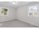 Bright bedroom featuring two windows and wall-to-wall carpet at 732 Queens Ave, Dunn, NC 28334