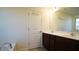 Double vanity bathroom with dark brown cabinets and a large mirror at 897 Golden Plum Ln, Zebulon, NC 27597