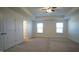 Spacious bedroom with neutral carpeting and two large windows at 897 Golden Plum Ln, Zebulon, NC 27597