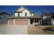 Two-story house with two-car garage and stone accents at 897 Golden Plum Ln, Zebulon, NC 27597
