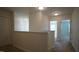 Upstairs hallway with carpet, doors to bedrooms and wall at 897 Golden Plum Ln, Zebulon, NC 27597