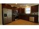 Modern kitchen with stainless steel appliances and dark wood cabinets at 897 Golden Plum Ln, Zebulon, NC 27597