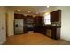 Modern kitchen with stainless steel appliances and dark wood cabinets at 897 Golden Plum Ln, Zebulon, NC 27597