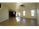 Bright living room with hardwood floors, kitchen view, and patio access at 897 Golden Plum Ln, Zebulon, NC 27597