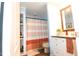 Bathroom featuring a shower/tub with curtain, wood look vanity, and shelves at 979 Natchez Trce, Fuquay Varina, NC 27526